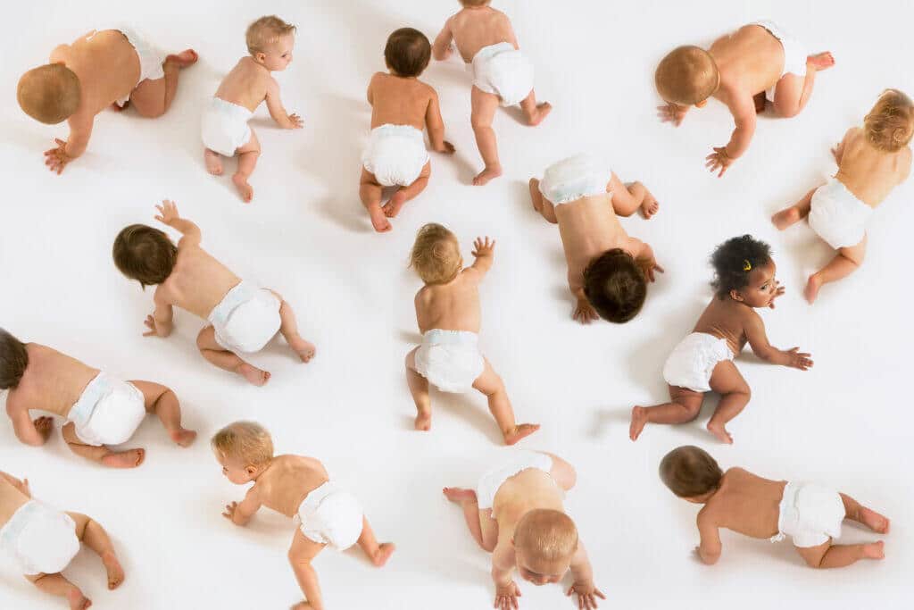 Babies crawling on white floor